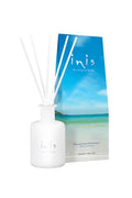 Inis Fragrance Diffuser white frosted bottle with white reed sticks next to blue beach-scene branded box, on white background